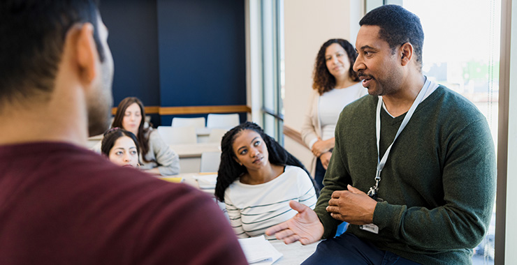 man talking with a group of young people