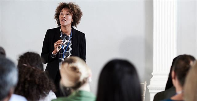 woman speaking in front of an audience