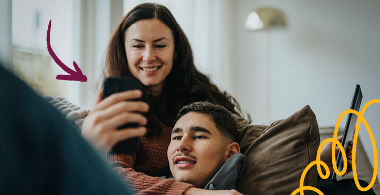 teen boy and mother looking at smartphone