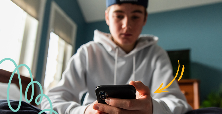 teen boy looking at chatbot on smartphone