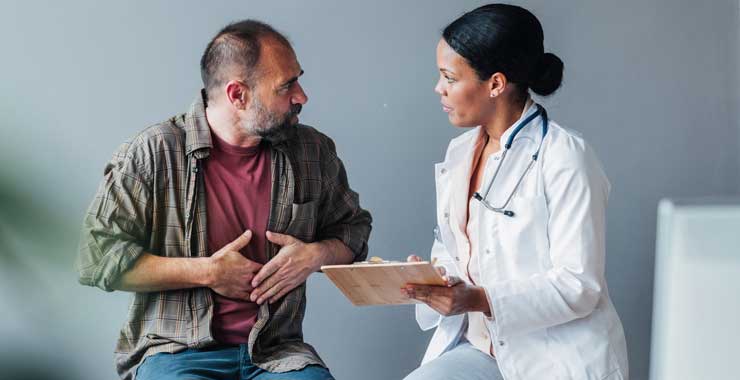 man explaining symptoms to a doctor