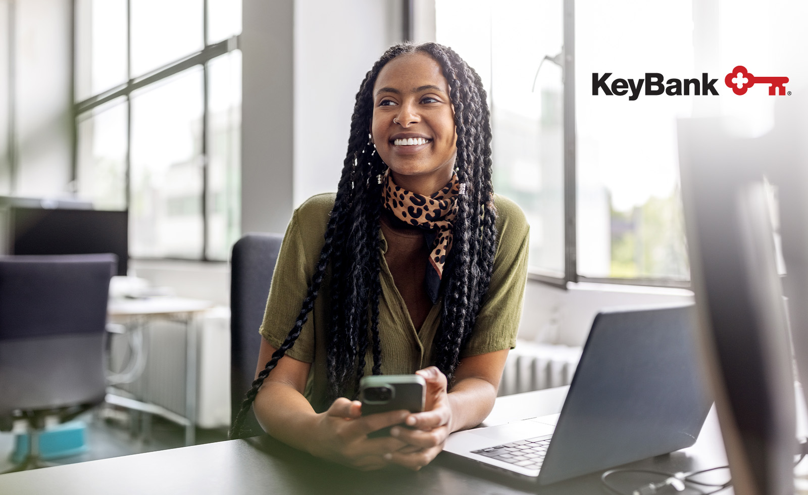 Woman smiling and holding her smartphone