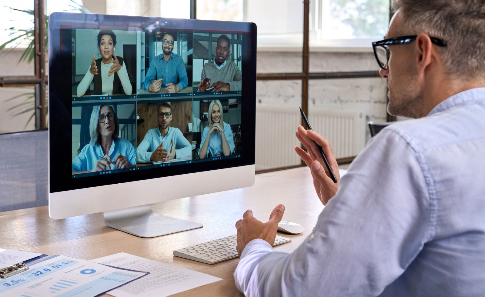 Corporate manager leading videoconference with team business people on computer