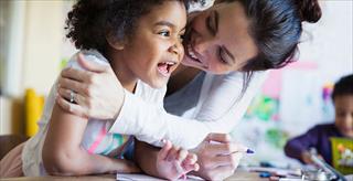 teacher and student in preschool classroom