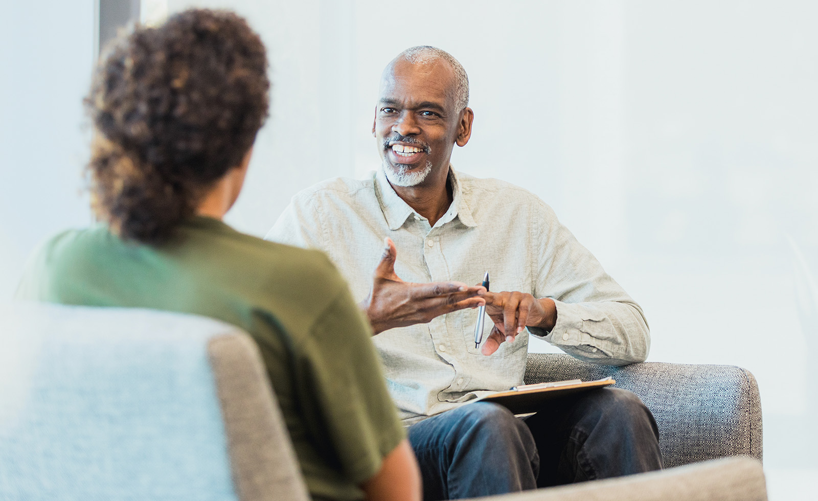 Older man with beard talking