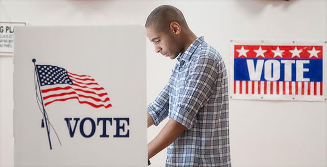 Black man casting a vote at a polling place