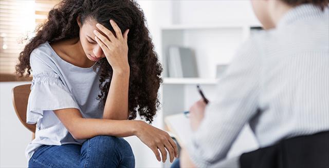 therapy session with young woman suffering from PTSD