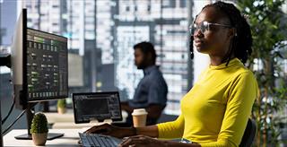 Young data scientist working at her computer.