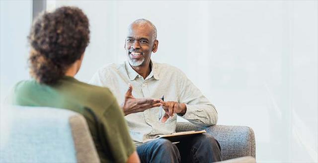 Older man with beard talking