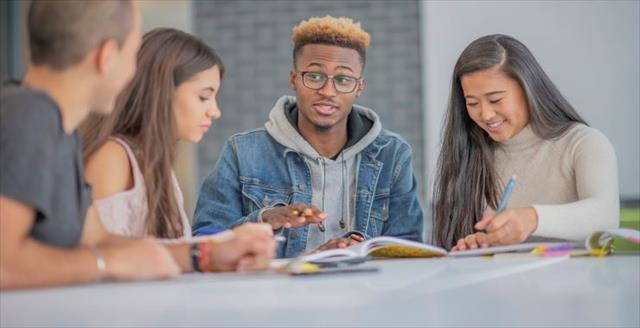 Group of college students works on project together