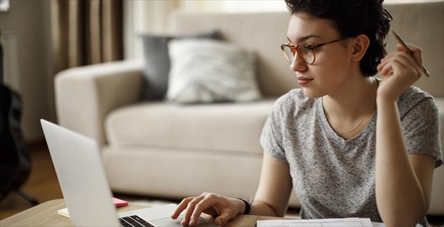 Woman working and focusing on laptop screen